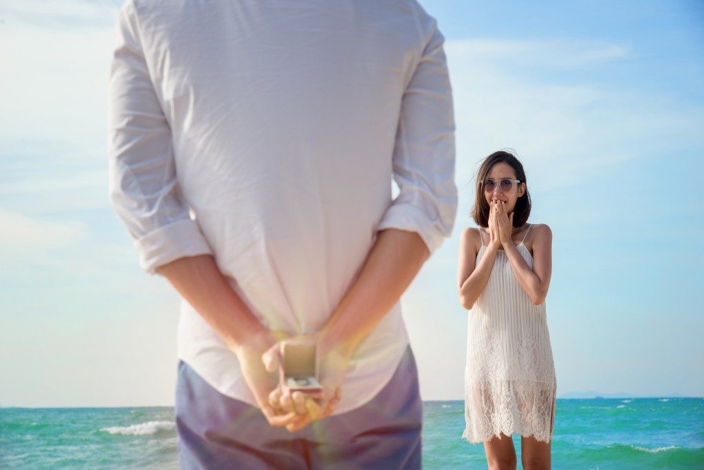 man with ring behind his back readying for a proposal