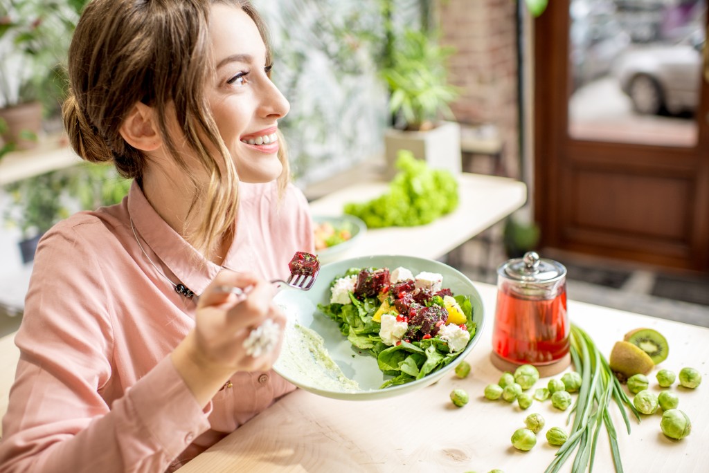 Woman eating salad