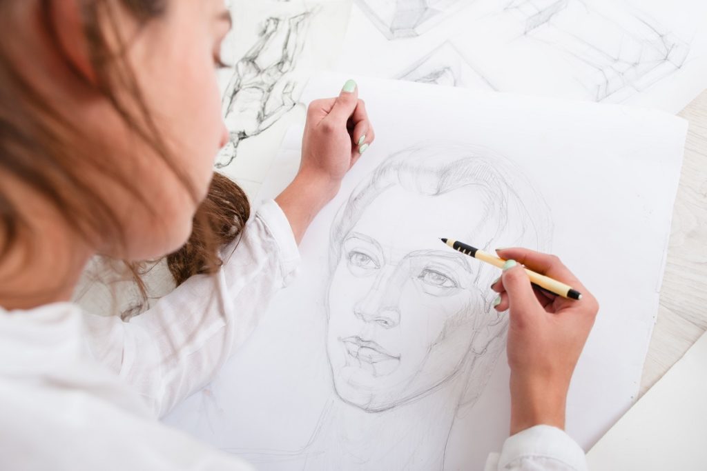 Woman drawing on a paper