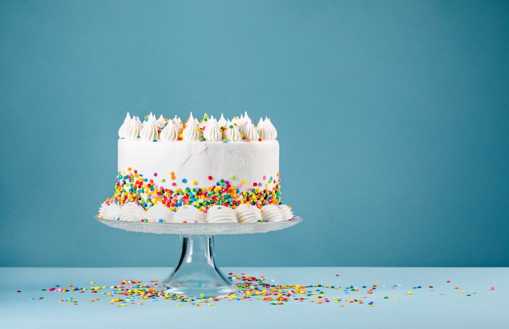 birthday cake on a stand and blue background