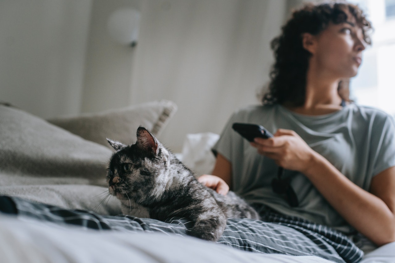 women in her pajamas with her cat