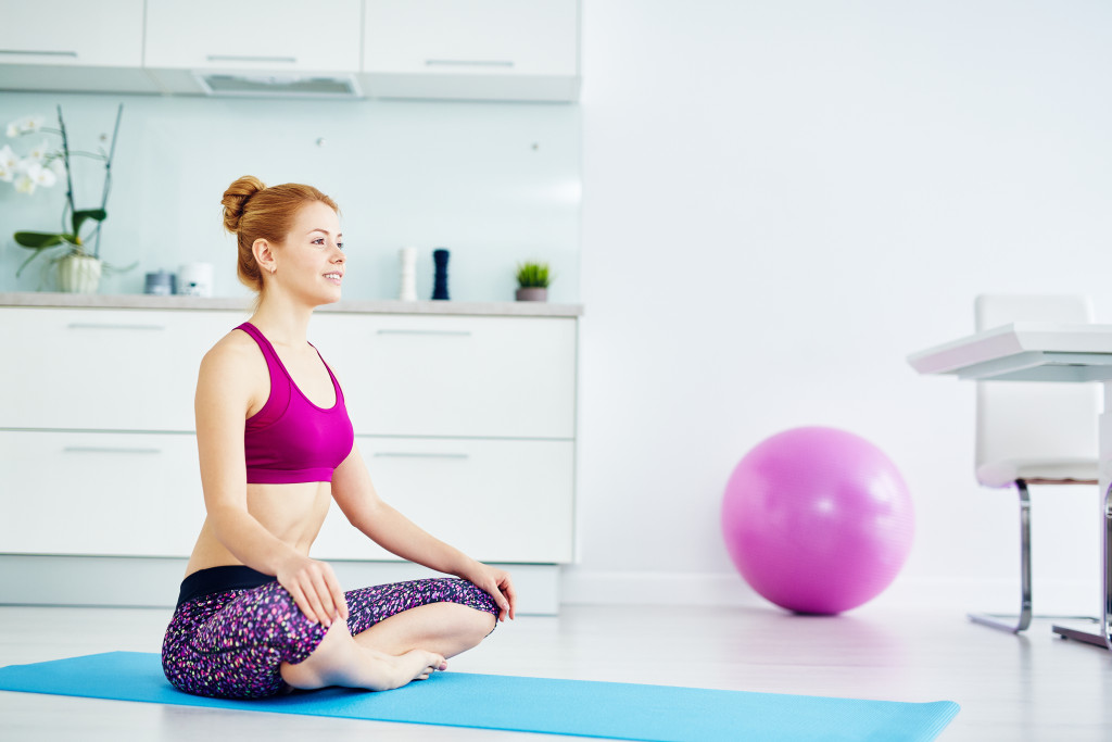 woman sitting on a yoga mat