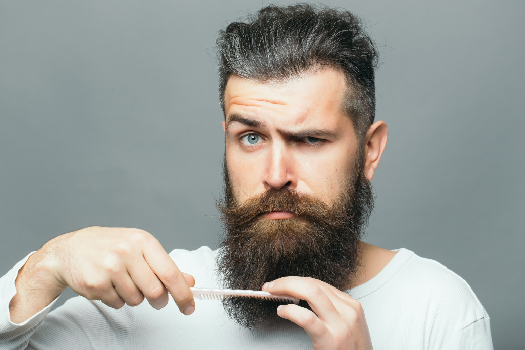 man deciding whether to grow out beard or not