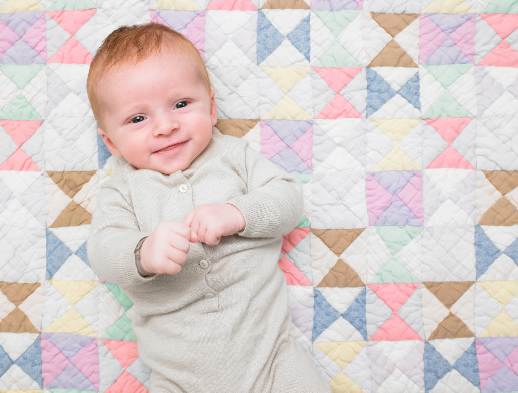 Smiling baby on quilt