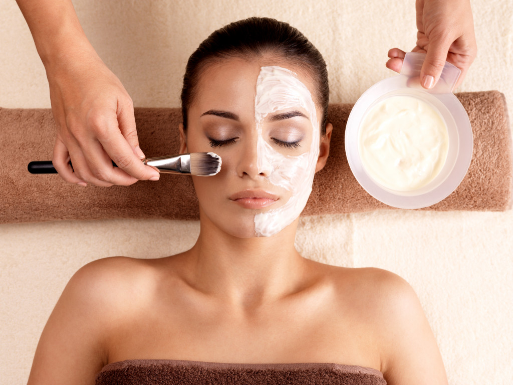 woman sleeping while having facial treatment in a spa