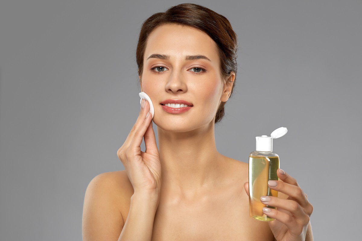 woman applying cleanser in her face