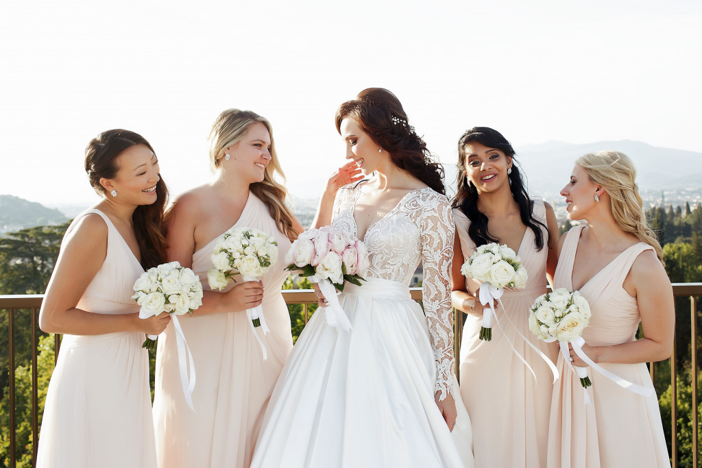 bride in the middle with her matching bridesmaids outdoors