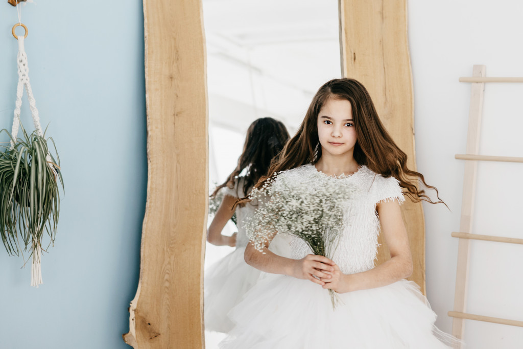 flower girl holding bouquet of flowers in white dress