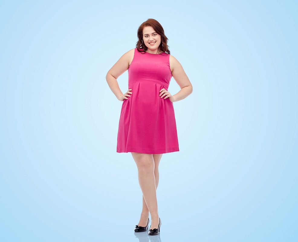 plus size woman posing in pink dress