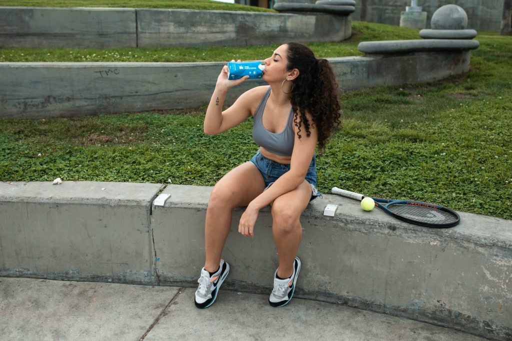 Woman hydrating after exercising